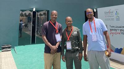 Three African entrepreneurs stand outside the conference centre hosting the Saudi Food Show