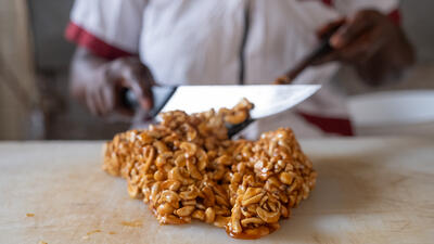 Close-up of cashews being worked into snacks