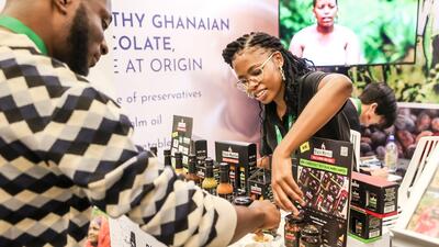 Eswatini woman serves samples of chili sauce to customer