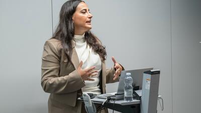 Woman in business attire speaks to workshop on trade in Moldova